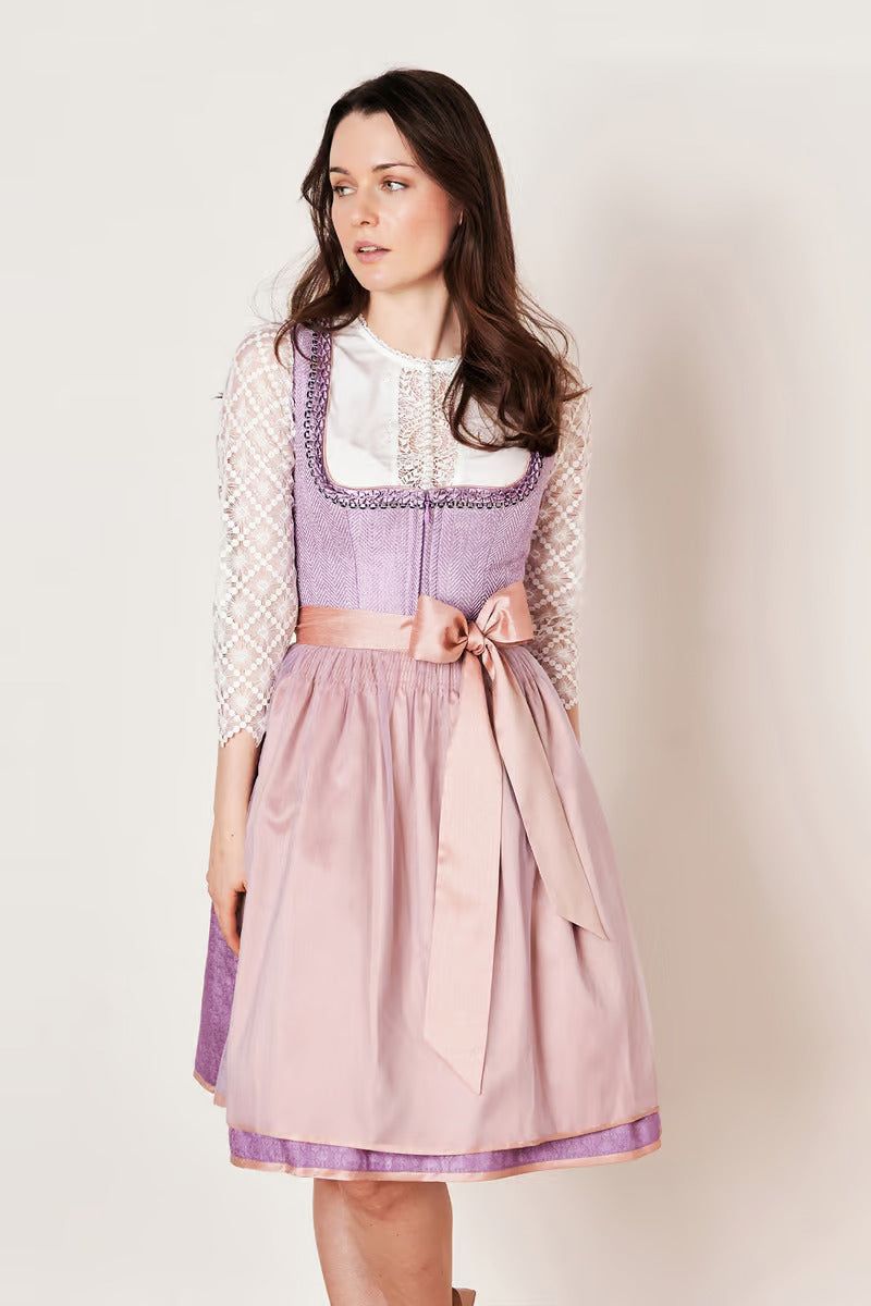 Kruger Midi Dirndl Amaya in purple with pink apron, sleeveless design, 60cm skirt length, and contemporary look.
